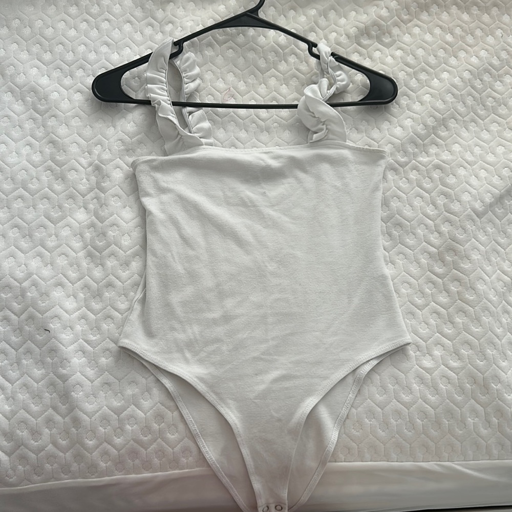 white bodysuit with ruffle sleeves